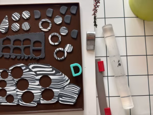 Wildberry polymer clay earrings featuring zebra and leopard print patterns, photographed for a blog post.